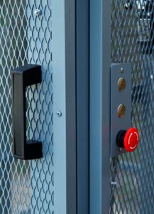 Powder coated grey mezzanine lift with push buttons with e-stop door and handle